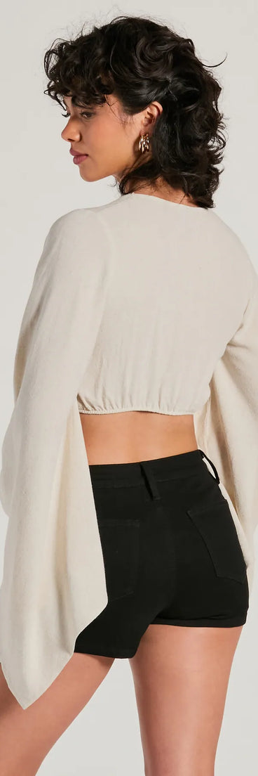 The Breezy Energy Tie Front Long Sleeve Linen Top is a women's natural long-sleeve top with festive style and unique design accents, perfect for layering during the holiday season or transitioning into colder months.