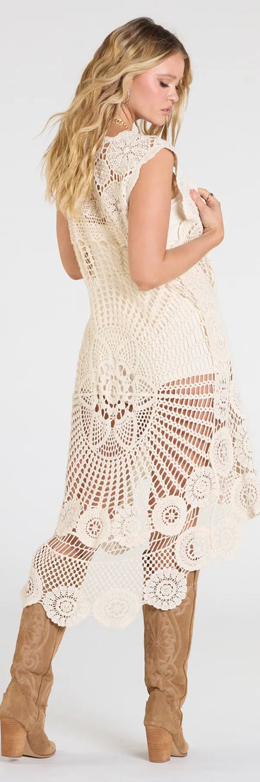 The Somewhere Fun Crochet Vest Duster in ivory brings edge and energy to your vibe, ready to elevate any festival look or concert outfit.