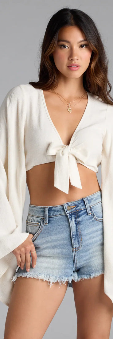With its midriff cut and trend-forward fit, the Bring The Drama Bell Sleeve Tie Front Crop Top is a natural crop top made to pair with skirts, denim, or whatever vibe you're feeling this season.
