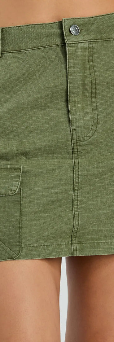 The Attention Please High-Rise Cargo Mini Skirt is a trendy women's bottom in olive green, designed with modern details and alluring textures to complete chic outfits for 2025.