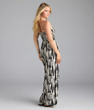 Complete your summer wardrobe with the Remarkable Energy Abstract Striped Wide-Leg Jumpsuit, a trendy jumpsuit in black made to mix, match, and stand out.