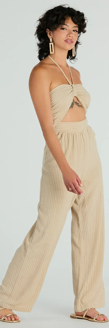 The Coastal Cutie Halter Cutout Striped Linen Jumpsuit in taupe is a women's jumpsuit with an on-trend leg style and elevated fabric that adds texture, perfect for crafting effortless winter outfits.