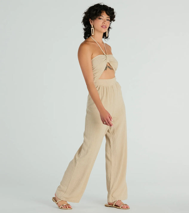 The Coastal Cutie Halter Cutout Striped Linen Jumpsuit in taupe is a women's jumpsuit with an on-trend leg style and elevated fabric that adds texture, perfect for crafting effortless winter outfits.