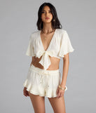 Complete your summer wardrobe with the Effortless Chic Mid-Rise Ruffled Shorts, trendy shorts in off-white made to mix, match, and stand out.