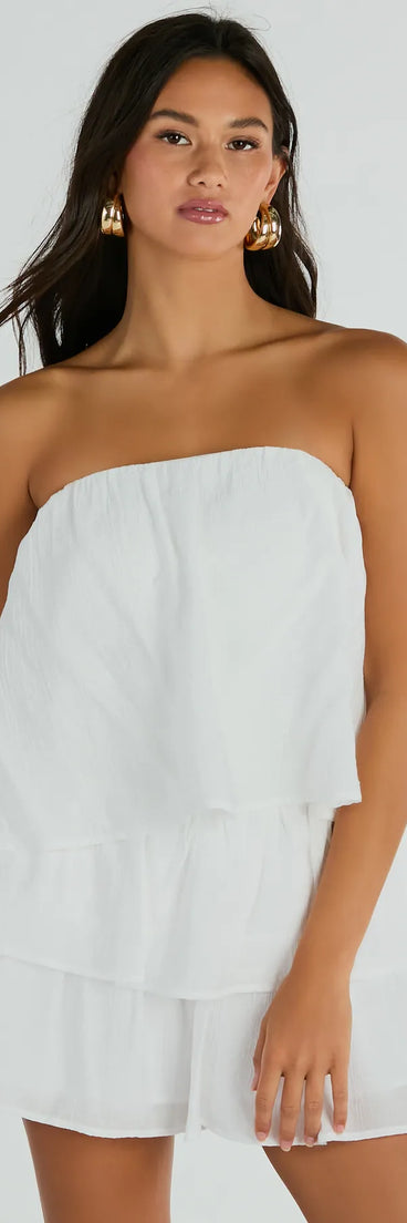 The Poolside Vacay Strapless Ruffled Romper is an elevated one-piece that blends sleek sophistication with playful charm, perfect for nailing casual or formal outfits.