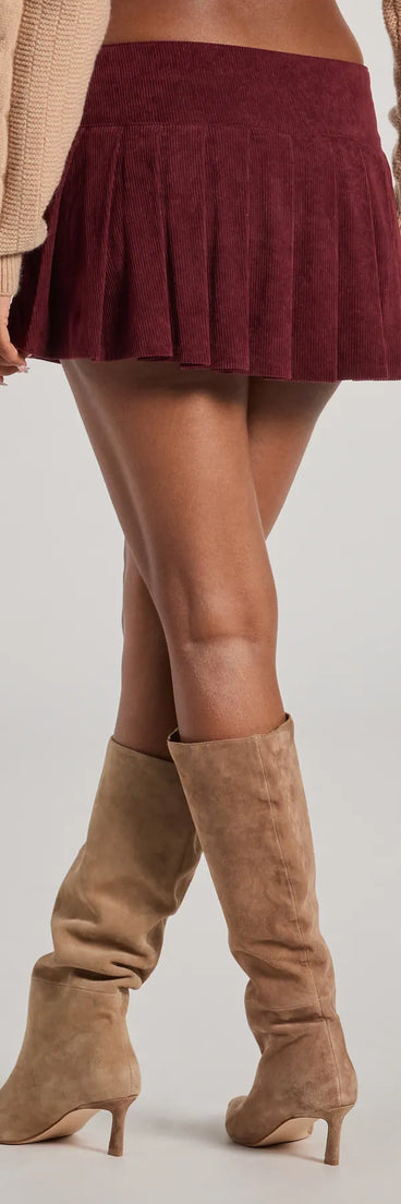 The Trendy Status Corduroy Pleated Drop Waist Mini Skort is a trendy women's bottom in wine, designed with modern details and alluring textures to complete chic outfits for 2025.