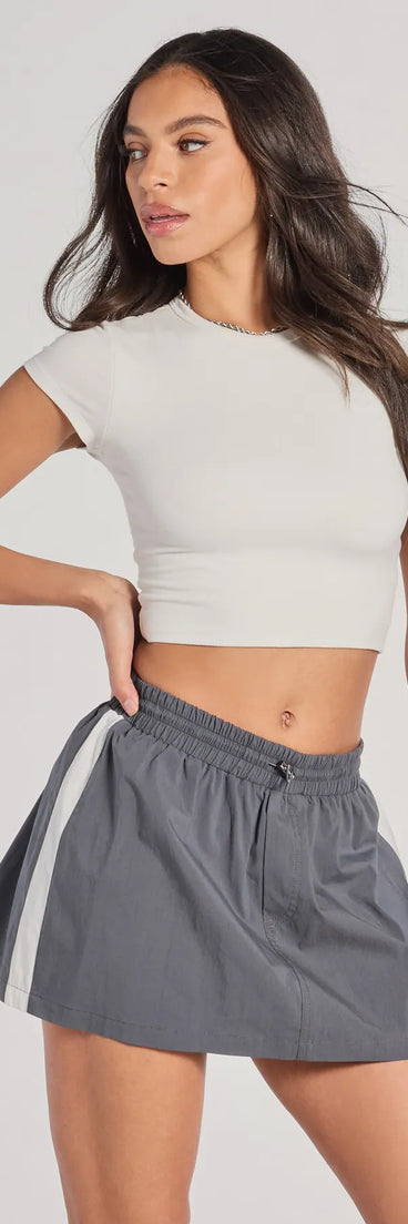 The Classically Sporty High-Rise Striped Skort is a trendy women's bottom in charcoal, designed with modern details and alluring textures to complete chic outfits for 2025.