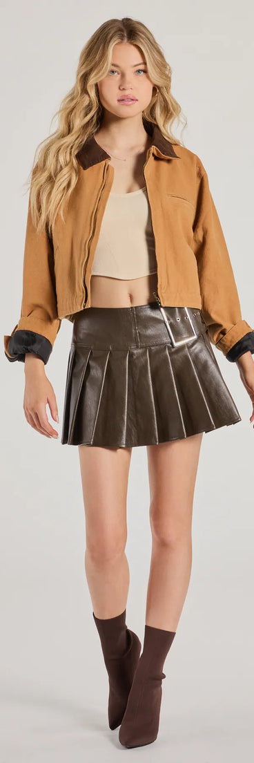 The City Chic Faux Leather Pleated Mini Skirt in brown is a women's workwear essential with an elevated fabric and chic silhouette, ideal for layering and versatile enough to take your look from office chic to going-out ready!