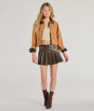 The City Chic Faux Leather Pleated Mini Skirt in brown is a women's workwear essential with an elevated fabric and chic silhouette, ideal for layering and versatile enough to take your look from office chic to going-out ready!