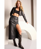 The Sleek Era Faux Leather High Slit Midi Skirt is a trendy women's bottom, designed with modern details and alluring textures to complete chic outfits for 2025.