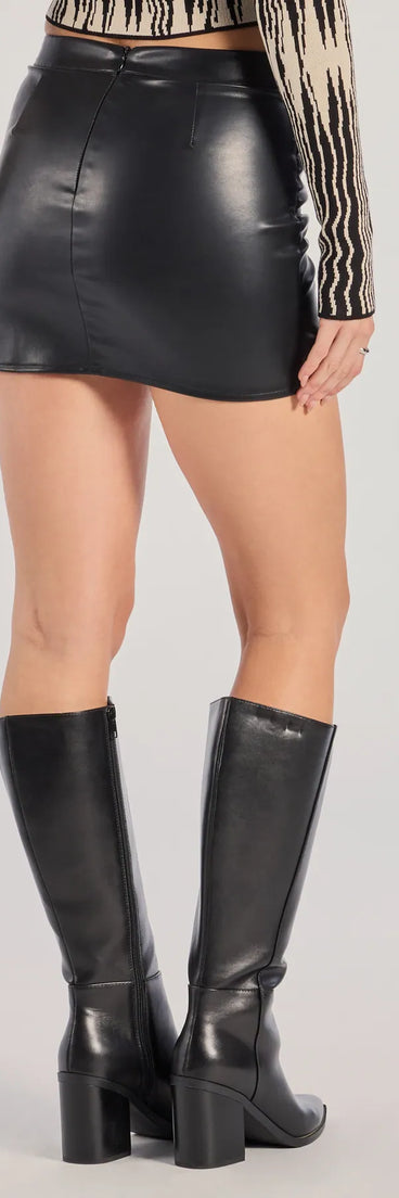 The Sleek Allure Faux Leather Wrap-Front Mini Skirt is a trendy women's bottom in black, designed with modern details and alluring textures to complete chic outfits for 2025.