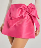 Create bold, fashion-forward looks for spring or summer with the Adorable Muse Bow Detail Mini Skirt in fuchsia, a must-have piece from Windsor’s collection of stylish bottoms for women.