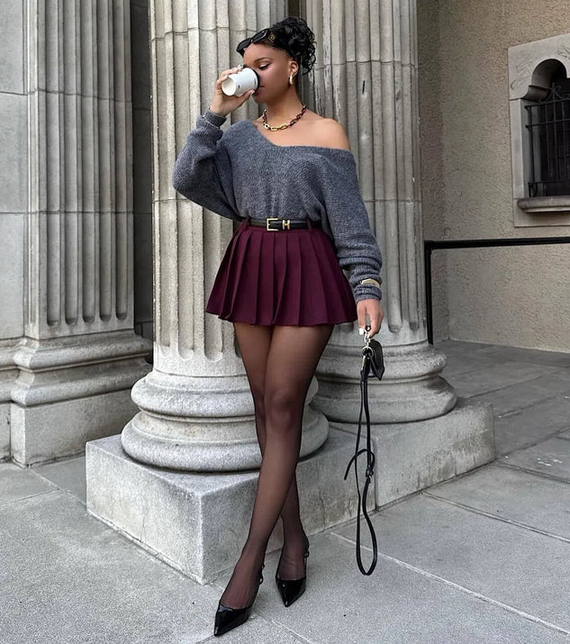 The Downtown Girl Belted Pleated Mini Skirt is a trendy women's bottom in plum, designed with modern details and alluring textures to complete chic outfits for 2025.