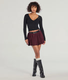 Create bold, fashion-forward looks for spring or summer with the Downtown Girl Belted Pleated Mini Skirt in plum, a must-have piece from Windsor’s collection of stylish bottoms for women.