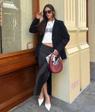 Choosing the black skirt says you’re ready to show off in the There She Goes High-Rise Slit Polka Dot Satin Midi Skirt, a warm-weather staple that elevates your outfit and seasonal style.