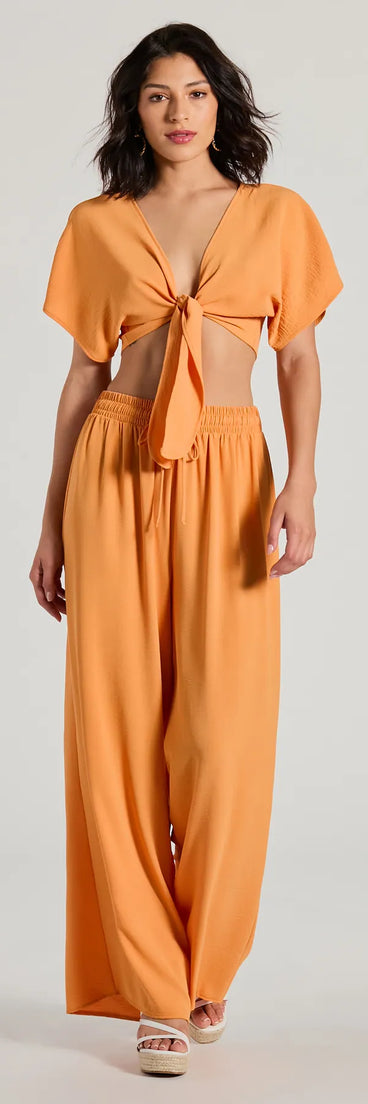 The Flirty Match High-Rise Palazzo Pants in orange is a pair of women's pants with an on-trend leg style and elevated fabric that adds texture, perfect for crafting effortless winter outfits.