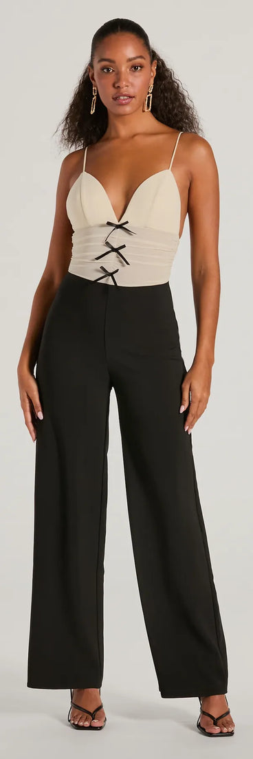 The Sweet And Chic Bow Detail Sleeveless Jumpsuit, a women's black jumpsuit, is a chic one-piece outfit for parties and celebrations offering a glamorous look with festive style and on-trend design accents.