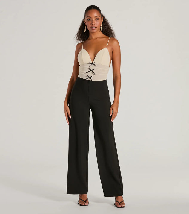 The Sweet And Chic Bow Detail Sleeveless Jumpsuit, a women's black jumpsuit, is a chic one-piece outfit for parties and celebrations offering a glamorous look with festive style and on-trend design accents.