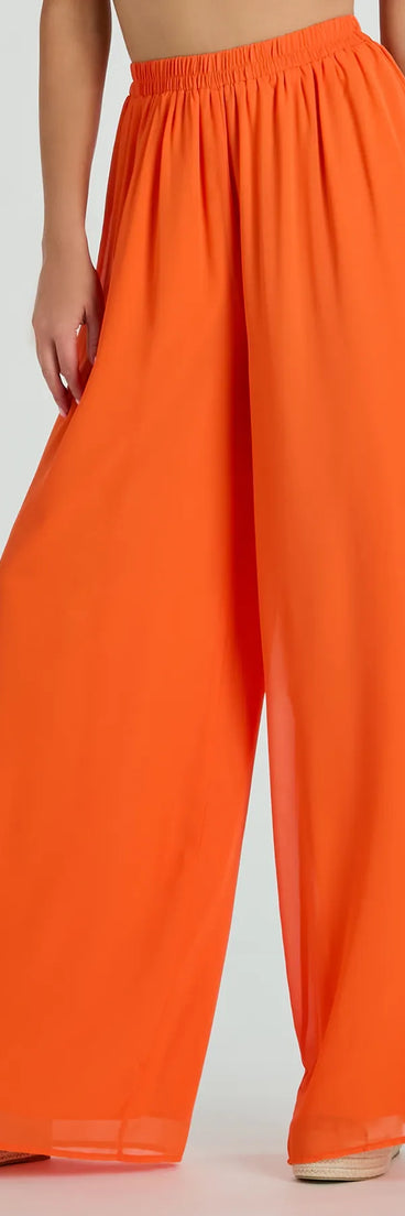 The Gorgeous Allure Chiffon Palazzo Pants in orange is a versatile pair of women's pants with trendy design accents, crafted for holiday-ready looks, from office wear to sophisticated winter night outs.
