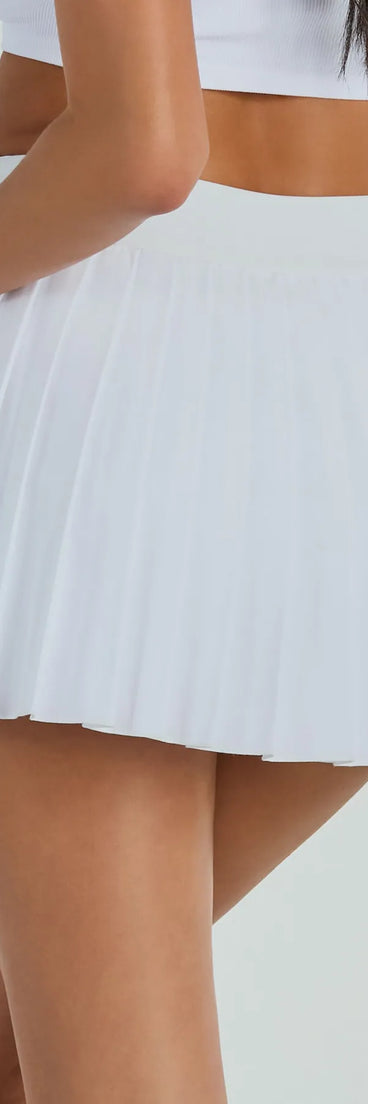 The Set And Match Pleated Tennis Skort is a trendy women's bottom in off-white, designed with modern details and alluring textures to complete chic outfits for 2025.