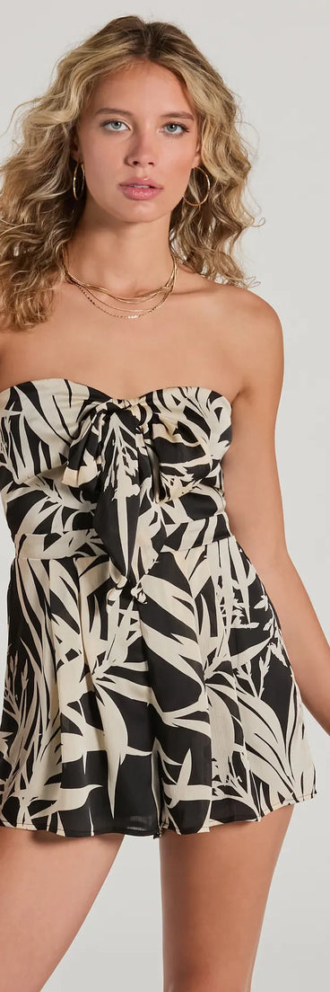 Perfect as a dress alternative for a New Year's outfit, wedding guest attire, and cocktail party dress alike, the Exotic Vibes Strapless Tie-Front Tropical Romper is a women's black romper that combines a stylish, unique design with festive colors and holiday-ready details for a standout look!