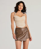 The Chic Factor Wrap-Front Faux Leather Skort in brown brings edge and energy to your vibe, ready to elevate any festival look or concert outfit.