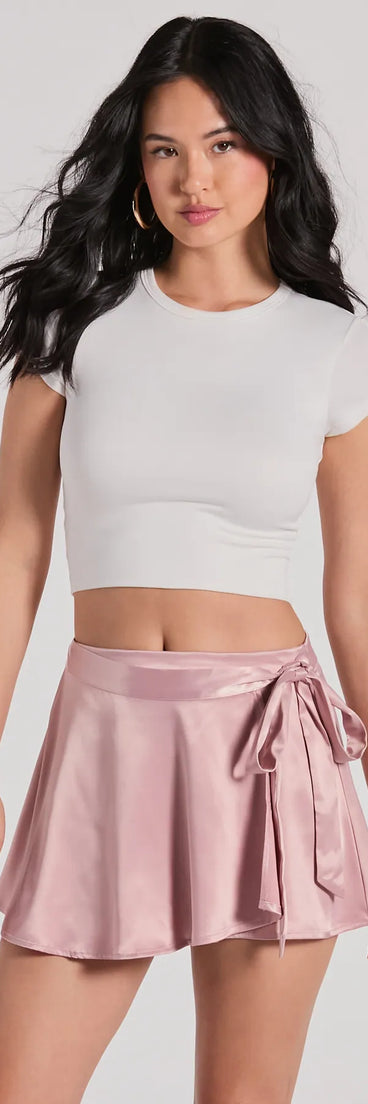 Designed for campus outfits, sleek workwear, and on-the-go moments, the Releve Cutie Faux Wrap Satin Skater Skirt is a trendy mauve bottom for women bringing effortless fall versatility.