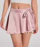 Create bold, fashion-forward looks for spring or summer with the Releve Cutie Faux Wrap Satin Skater Skirt in mauve, a must-have piece from Windsor’s collection of stylish bottoms for women.