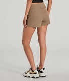 The Perfect Delight High Rise Scallop Wrap Mini Skort in taupe is a women's workwear piece offering a trendy style and unique accents, perfect for effortlessly creating an outfit-of-the-day look that transitions your office look to going-out ready.