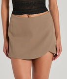 The Perfect Delight High Rise Scallop Wrap Mini Skort in taupe is a women's workwear essential with an elevated fabric and chic silhouette, ideal for layering and versatile enough to take your look from office chic to going-out ready!