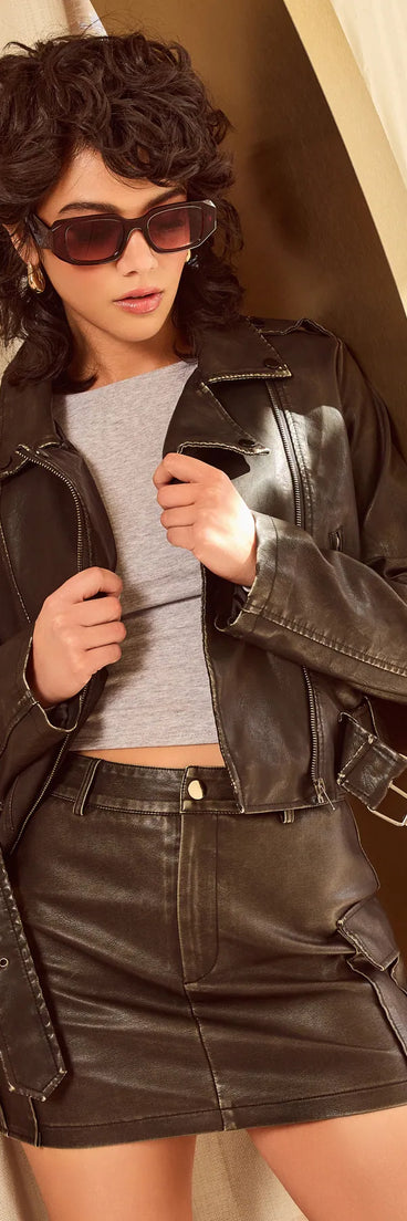 The Edgy Cuteness High-Rise Cargo Faux Leather Mini Skort is a trendy women's bottom in black, designed with modern details and alluring textures to complete chic outfits for 2025.