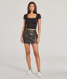 The Edgy Cuteness High Rise Cargo Faux Leather Mini Skort offers a discreetly comfy fit with shorts under a stylish skirt overlay featuring the latest accents and details.