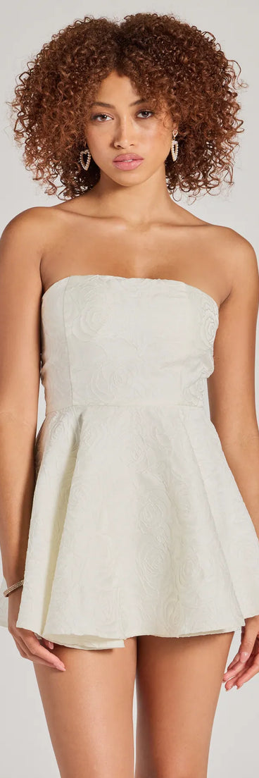 Perfect as a dress alternative for a date-night outfit, wedding guest attire, and cocktail party dress alike, the Angelic Looks Strapless Floral Satin Romper is a women's ivory romper that combines a stylish, unique design with festive colors and on-trend details for a standout look!