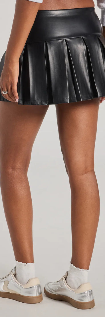 The Playful Pleats Faux Leather Drop Waist Skort is a trendy women's bottom in black, designed with modern details and alluring textures to complete chic outfits for 2025.