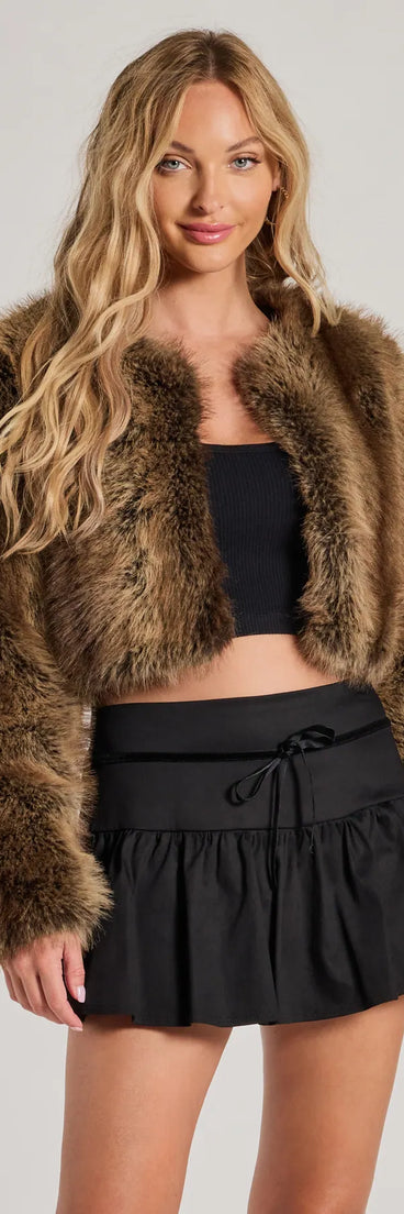 The Looking Chic Bow Trim Drop Waist Mini Skort is a trendy women's bottom in black, designed with modern details and alluring textures to complete chic outfits for 2025.