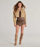 Create bold, fashion-forward looks for spring or summer with the Sleek And Trendy Belted Faux Leather Mini Skort in brown, a must-have piece from Windsor’s collection of stylish bottoms for women.