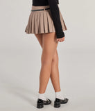 The Pleated Perfection Drop Waist Belted Skort in taupe is a women's workwear piece offering a trendy style and unique accents, perfect for effortlessly creating an outfit-of-the-day look that transitions your office look to going-out ready.