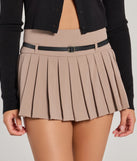 The Pleated Perfection Drop Waist Belted Skort in taupe is a women's workwear piece offering a trendy style and unique accents, perfect for effortlessly creating an outfit-of-the-day look that transitions your office look to going-out ready.