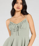 Create bold, fashion-forward looks for spring or summer with the Swept Away Tie-Back Ruffled Romper in sage green, a must-have piece from Windsor’s collection of stylish bottoms for women.