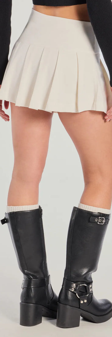 The Chic Mood Pleated Belted Skort is a trendy women's bottom in ivory, designed with modern details and alluring textures to complete chic outfits for 2025.