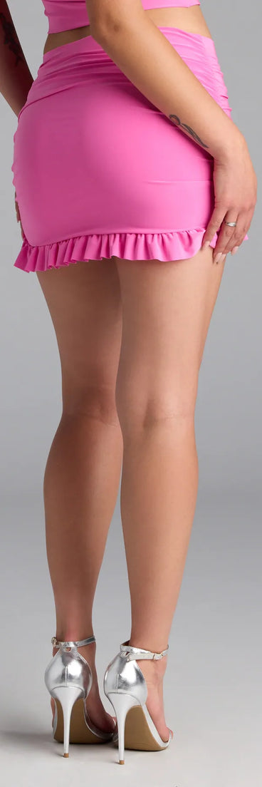 The Total Doll Ruffle Mini Skirt in pink features a short, flattering cut designed to elevate your look with just the right amount of edge.