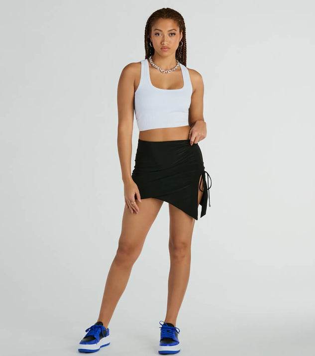 The Hold It Down Ruched Asymmetrical Mini Skirt in black brings edge and energy to your vibe, ready to elevate any festival look or concert outfit.