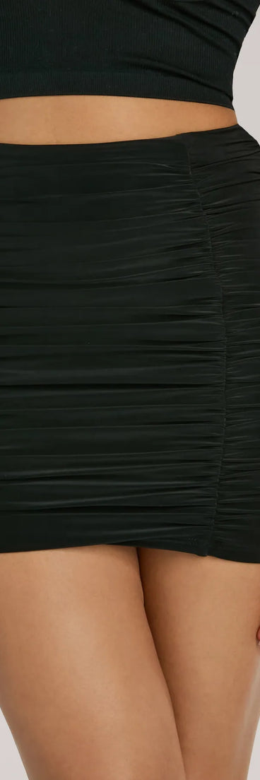 The Sassy Fun Ruched Bodycon Mini Skirt is a trendy women's bottom in black, designed with modern details and alluring textures to complete chic outfits for 2025.