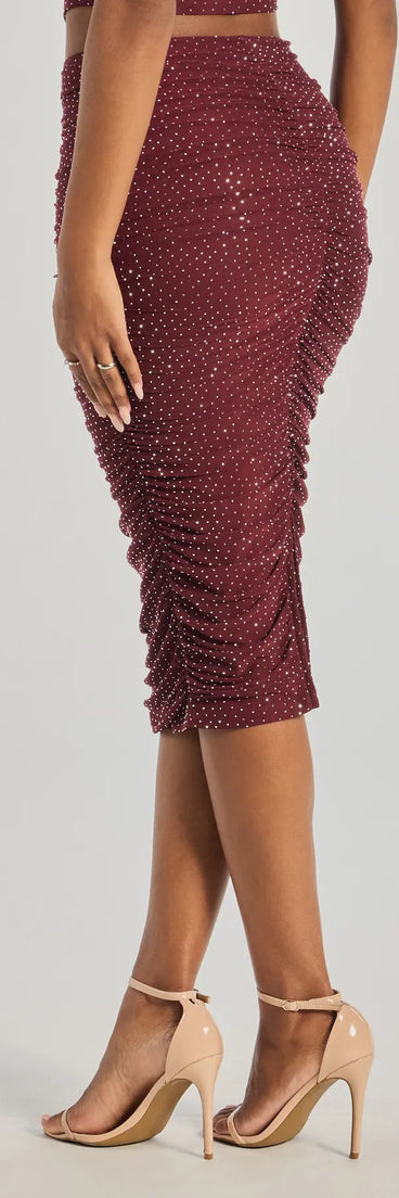 The Bright Vibes Ruched Rhinestone Midi Skirt is a trendy women's bottom in plum, designed with modern details and alluring textures to complete chic outfits for 2025.