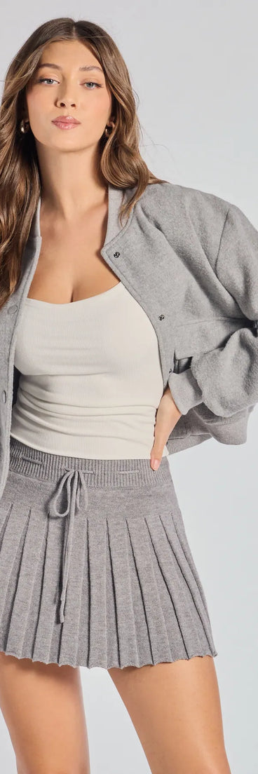 The Preppy Pleated Goals Mini Skirt is a trendy women's bottom in gray, designed with modern details and alluring textures to complete chic outfits for 2025.