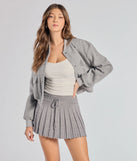 The Preppy Pleated Goals Mini Skirt is a trendy women's bottom in gray, designed with modern details and alluring textures to complete chic outfits for 2025.