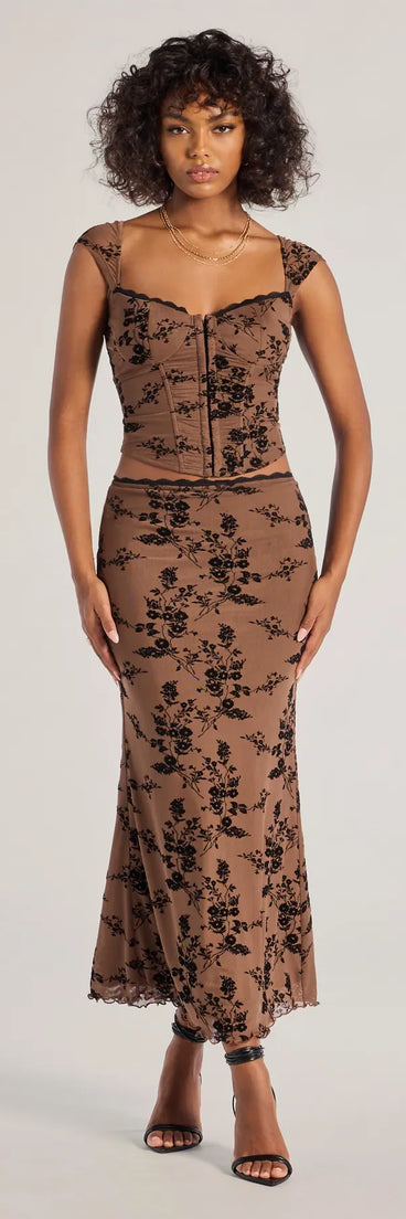 The Romantic Aura Flocked Floral Mesh Maxi Skirt is a trendy women's bottom in brown, designed with modern details and alluring textures to complete chic outfits for 2025.