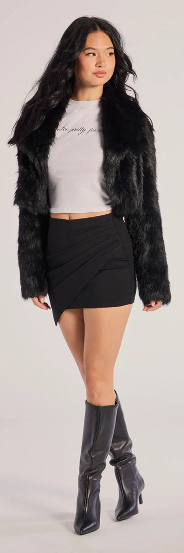 The Twist And Twirl Wrap Mini Skirt is a trendy women's bottom in black, designed with modern details and alluring textures to complete chic outfits for 2025.