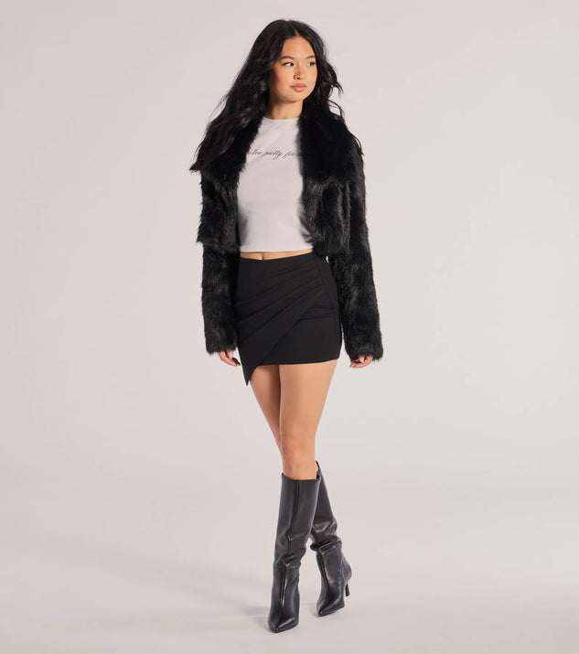 The Twist And Twirl Wrap Mini Skirt is a trendy women's bottom in black, designed with modern details and alluring textures to complete chic outfits for 2025.