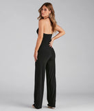 The Sleek And Sultry Halter Jumpsuit is a trendy women's bottom in black, designed with modern details and alluring textures to complete chic outfits for 2025.